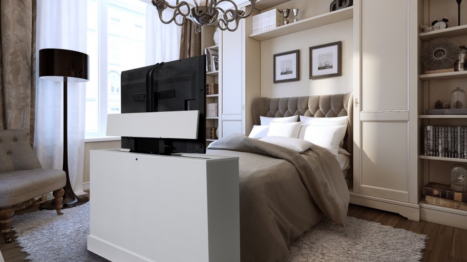 White TV lift cabinet at the foot of the bed in a contemporary bedroom, HDTV fully raised into viewing position